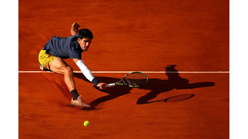 Carlos Alcaraz (Spain) stretches for a backhand against Alexander Zverev of Germany during the Men's Singles Final at Roland-Garros 2024 (Getty Images)