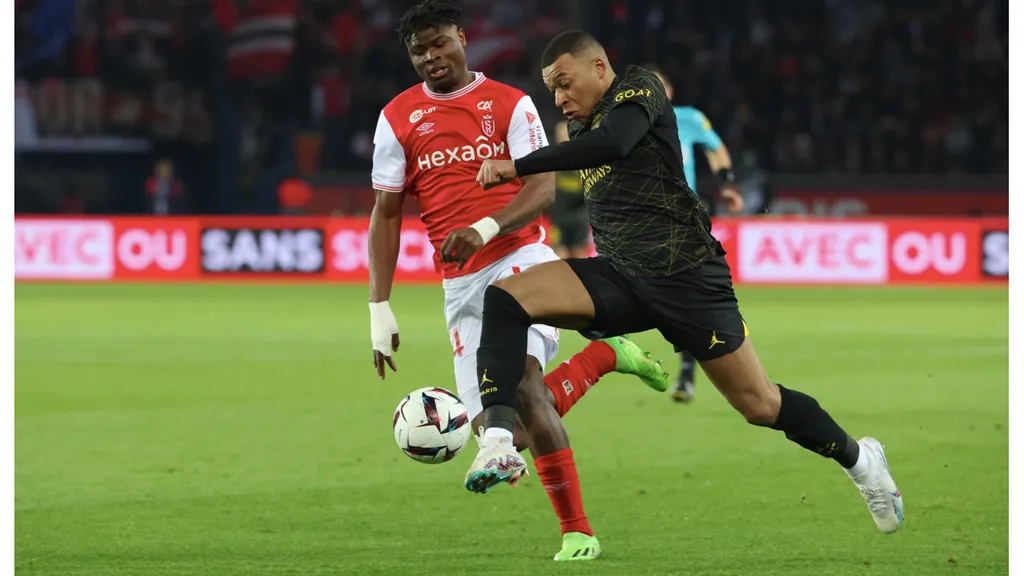 Kylian Mbappe (PSG) in action against Emmanuel Agbadou (Reims) in Ligue 1 (Getty Images).jpg