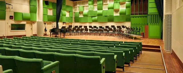 Studio 2 i radiohuset. gröna säten, grön väggdekor längst fram, scen.